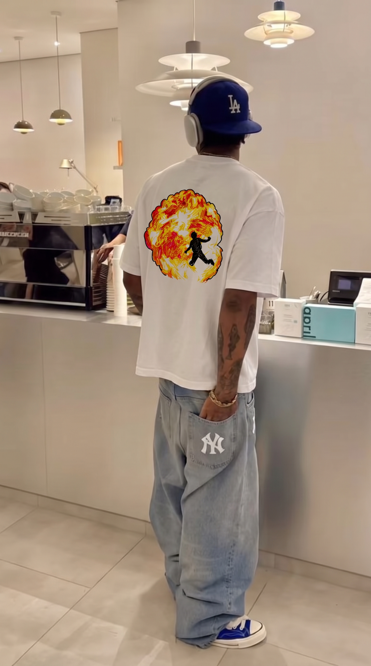 Metro Boomin tee, back print worn in a café