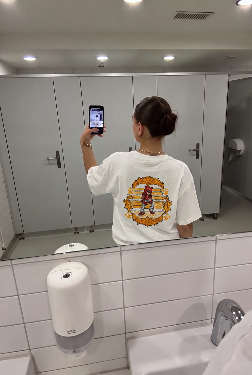 The College Dropout tee, back print in a mirror selfie