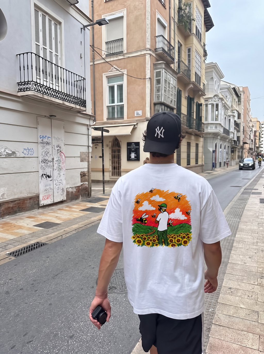 Flower Boy tee, back print worn on a city street
