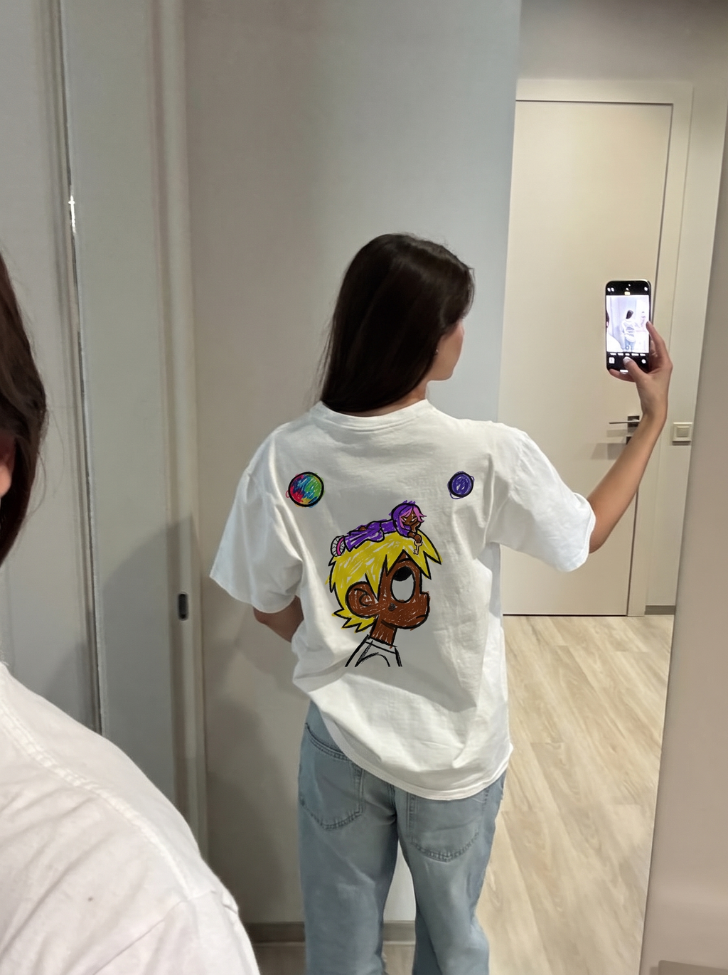 Baby Pluto tee, back print in a mirror selfie