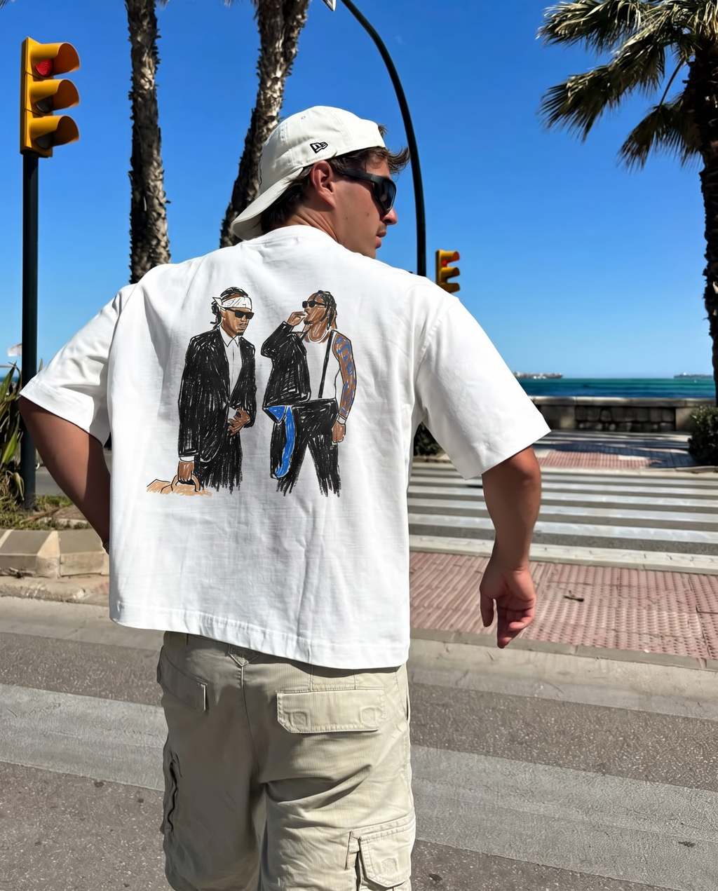 We Don't Trust You tee, back print worn by the seafront