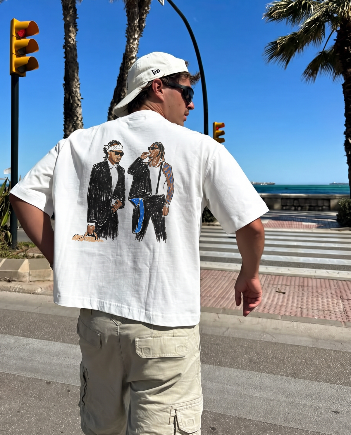 We Don't Trust You tee, back print worn by the seafront