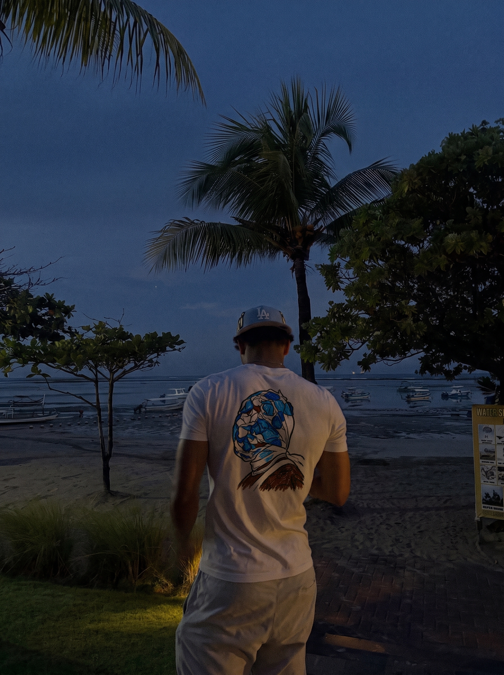 One of Wun tee, back print worn on the beach at night