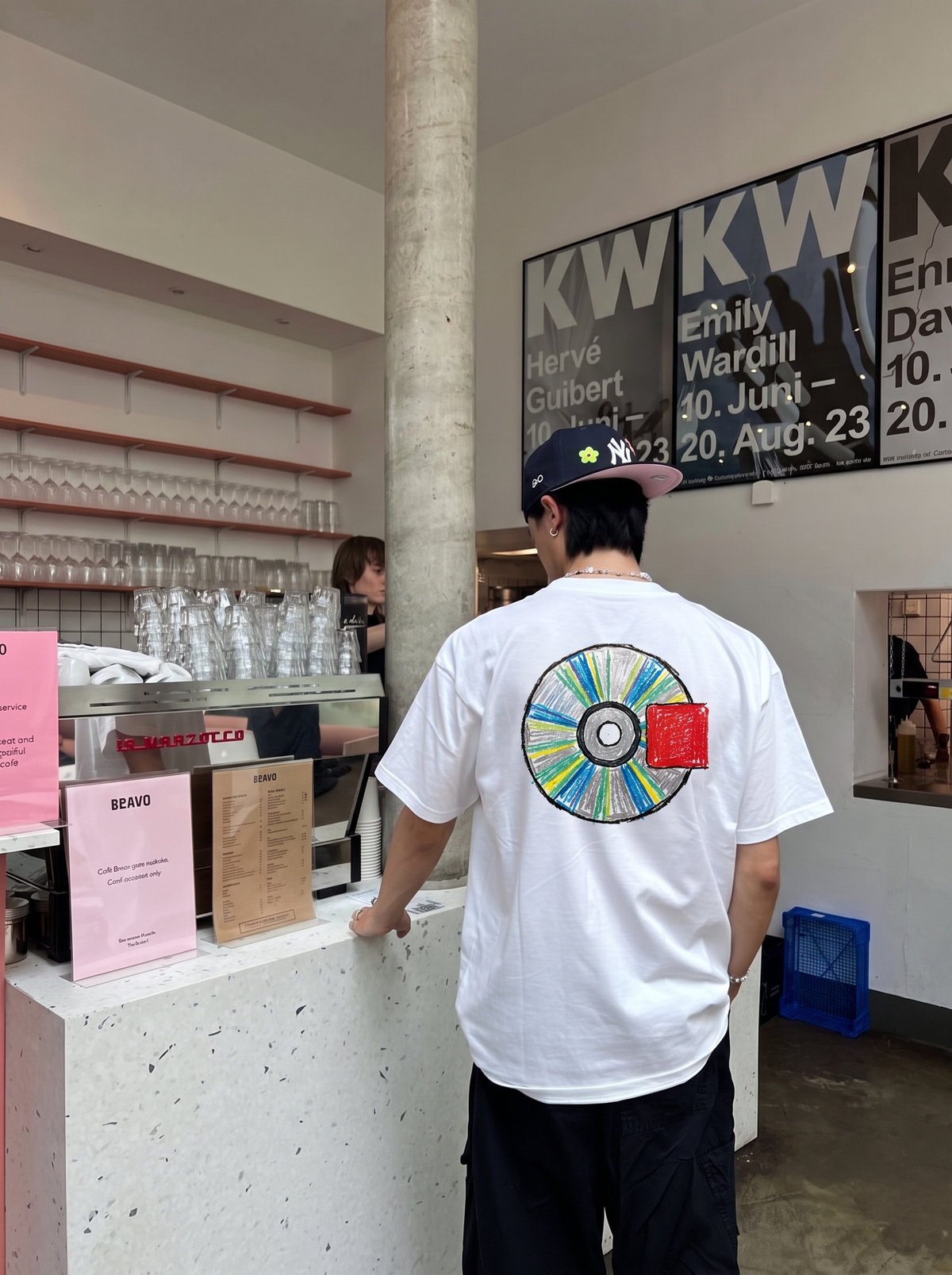 Yeezus tee, back print worn in a café