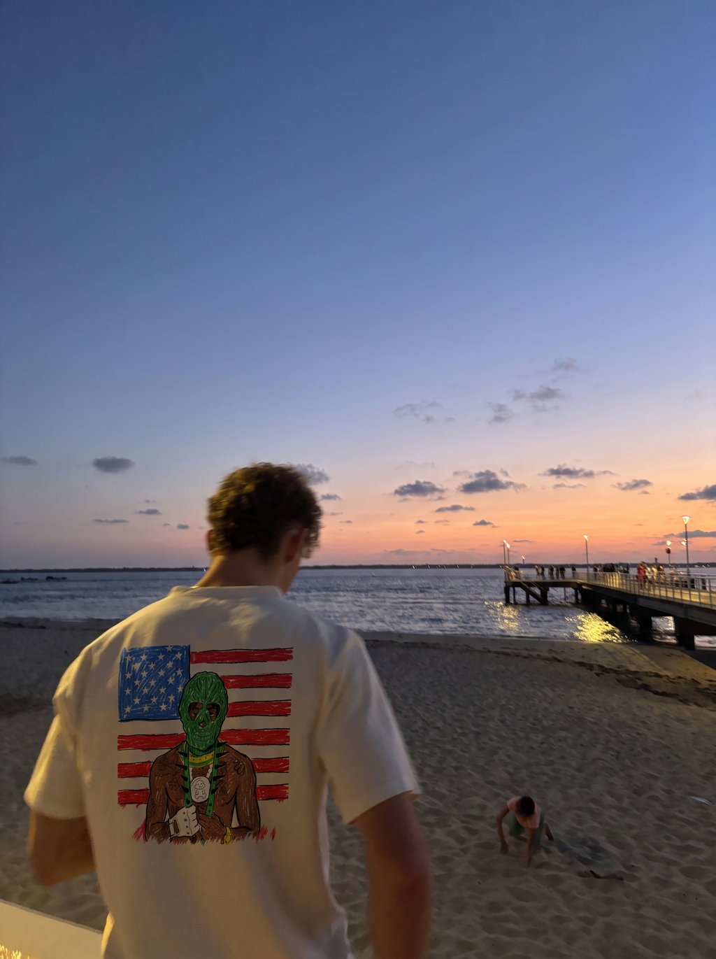 MASA tee, back print worn on the beach at sunset