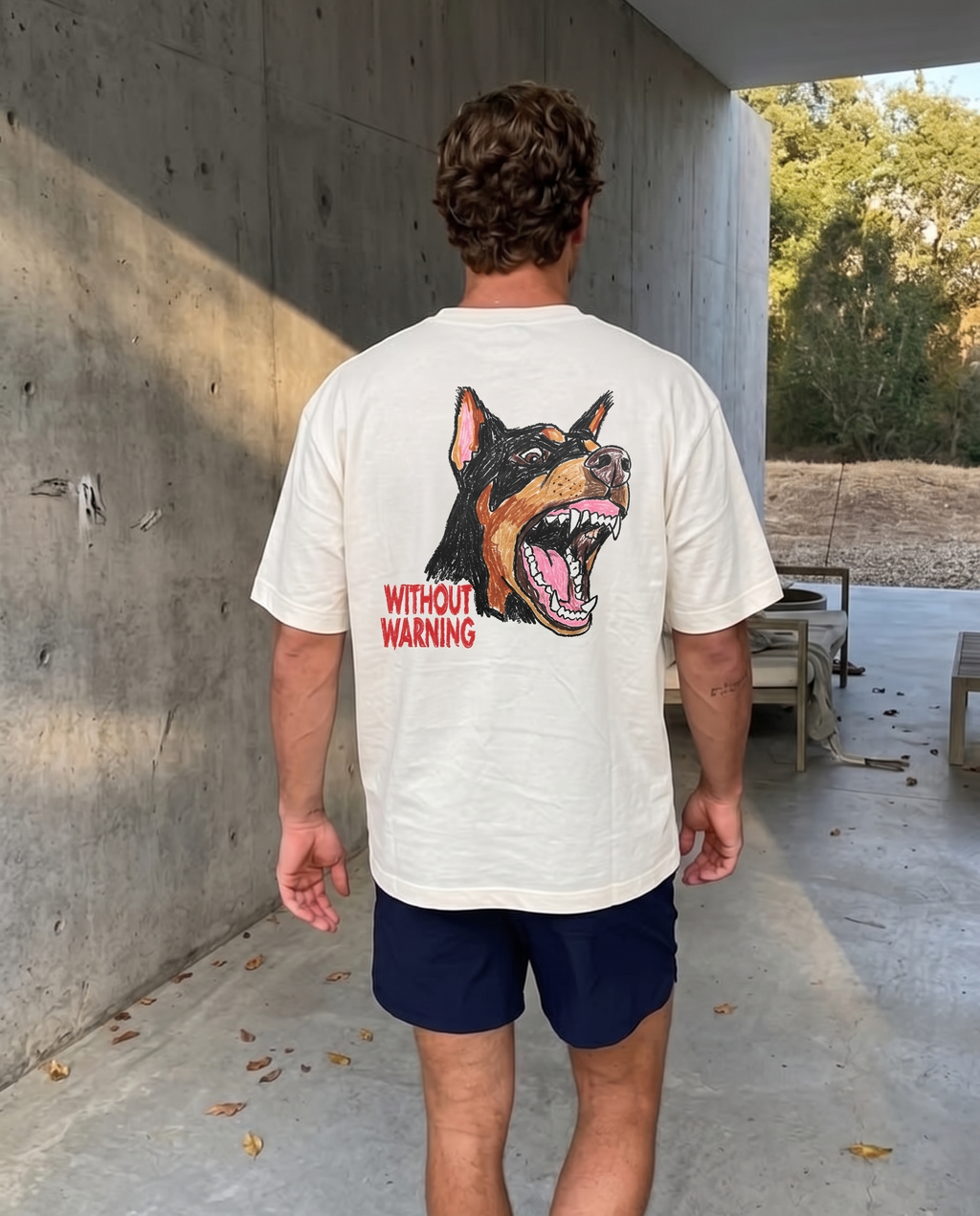 Without Warning tee, back print worn on a concrete walkway