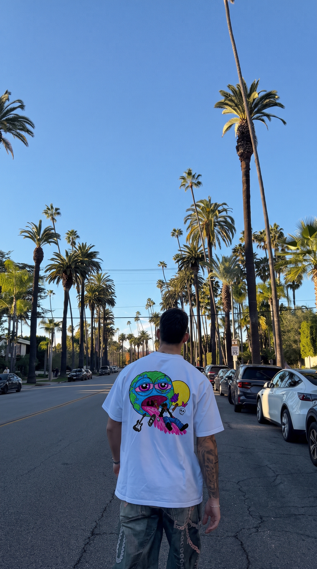 The Pre Party tee, back print worn on a palm-lined street