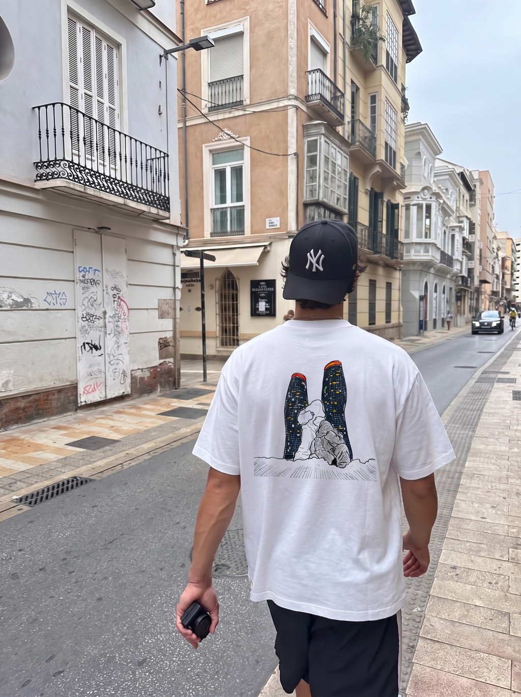 Some Sexy Songs 4 U tee, back print worn on a city street